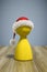 a red christmas hat on a yellow game figure