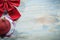 Red Christmas knot ball on wooden board holidays concept