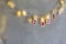 red christmas numbers 2021 on garland. New Year's lights in transparent clothespins. Gray background. Holiday decoration or