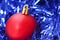 Red Christmas ornament on blue garland