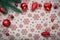 Red Christmas ornaments and xmas tree on canvas background with red glitter snowflakes. Xmas card. Happy New Year theme
