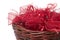 Red christmas ribbons in wicker basket