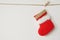 Red Christmas sock hanging on white wall background