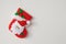 Red Christmas sock hanging on white wall background