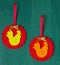 Red Christmas tree decoration in the form of a wavy circle with a rooster inside on a green background rooster