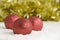 Red Christmas Tree Decorations and Gold Tinsel in Snow