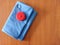 Red circle tape measure on blue fabric with wooden background with copy space