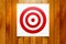 Red circle target hanging on wooden background