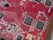 Red circuit board with chips and capacitors. Electronic board close-up