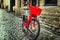 Red city bike on the cobblestones in the old cozy city of Europe. Close-up