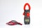 Red clamp multimeter measuring tool. clipping path