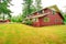 Red clapboard siding house with garage