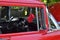 Red Classic car with black dashboard and red dice