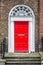 Red classic door in Dublin, example of georgian typical architecture of Dublin Ireland