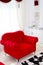 Red classical armchair and white curtains