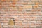 Red clay brick mixed with stones wall old texture. One bigger than other bricks for text and copyspace.