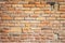 Red clay brick mixed with stones wall old texture. One bigger than other bricks for text and copyspace.