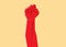 A red clenched fist hand raised in the air. Protest, strength, freedom, revolution, rebel, revolt concept design vector sign