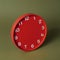 red clock without hands on a green background