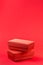 Red closed corrugated cardboard box on red