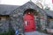 Red Closed door in a Strong Building constructed with strong stone wall