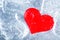 Red cloth heart in the ice