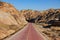 Red cobbled path leads through the stunning geological park in Zhangye, China.