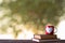 Red coffee cup placed on old wooden books background natural