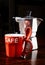 Red coffee cup and vintage coffeepot on dark wooden table