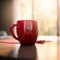 Red coffee cup on wooden desk on blurry background with bokeh.