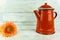 Red coffeepot with a colorful flower