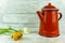 Red coffeepot with a colorful flower