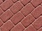 Red color cobblestone pavement surface.