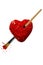 Red color painted heart pierced by paintbrush