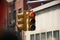 Red color traffic light with buildings in the background. Traffic light wallpaper.