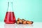 Red color unrefined palm oil and fruits with beaker in laboratory