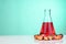 Red color unrefined palm oil and fruits with beaker in laboratory