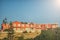 Red colored apartments in Greece with blue sunny sky at the background