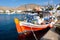 Red colored boat in the port of Karvostasi on the island of Folegandros. Cyclades,