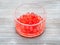 Red colored boiled tapioca bubbles in bowl on gray