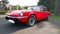 Red colored british six-cylinder sports car Triumph TR6