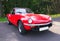 Red colored british six-cylinder sports car Triumph TR6