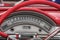 Red colored old american car details, wheel and speedometer.