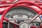 Red colored old american car details, wheel and speedometer.