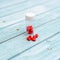 Red Colored Vitamins Pills on Wooden Background. Soft focused. Shallow depth of field