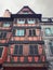 Red colored wooden building facade in Strasbourg city, France, Alsace. Historic town traditional timber framing houses