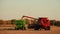 Red Combine Harvester and Green Grain Wagon