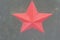 Red communist star on cracked khaki wall