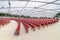 Red concert chairs in the Jay Pritzker Pavilion, located centrally in Millennium Park in Chicago.