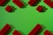 Red constructor cubes pattern on green background with copy space